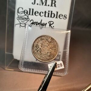 Toned 1960 Canada 50 Cents Elizabeth II 1st portrait, complete coat of arms KM#